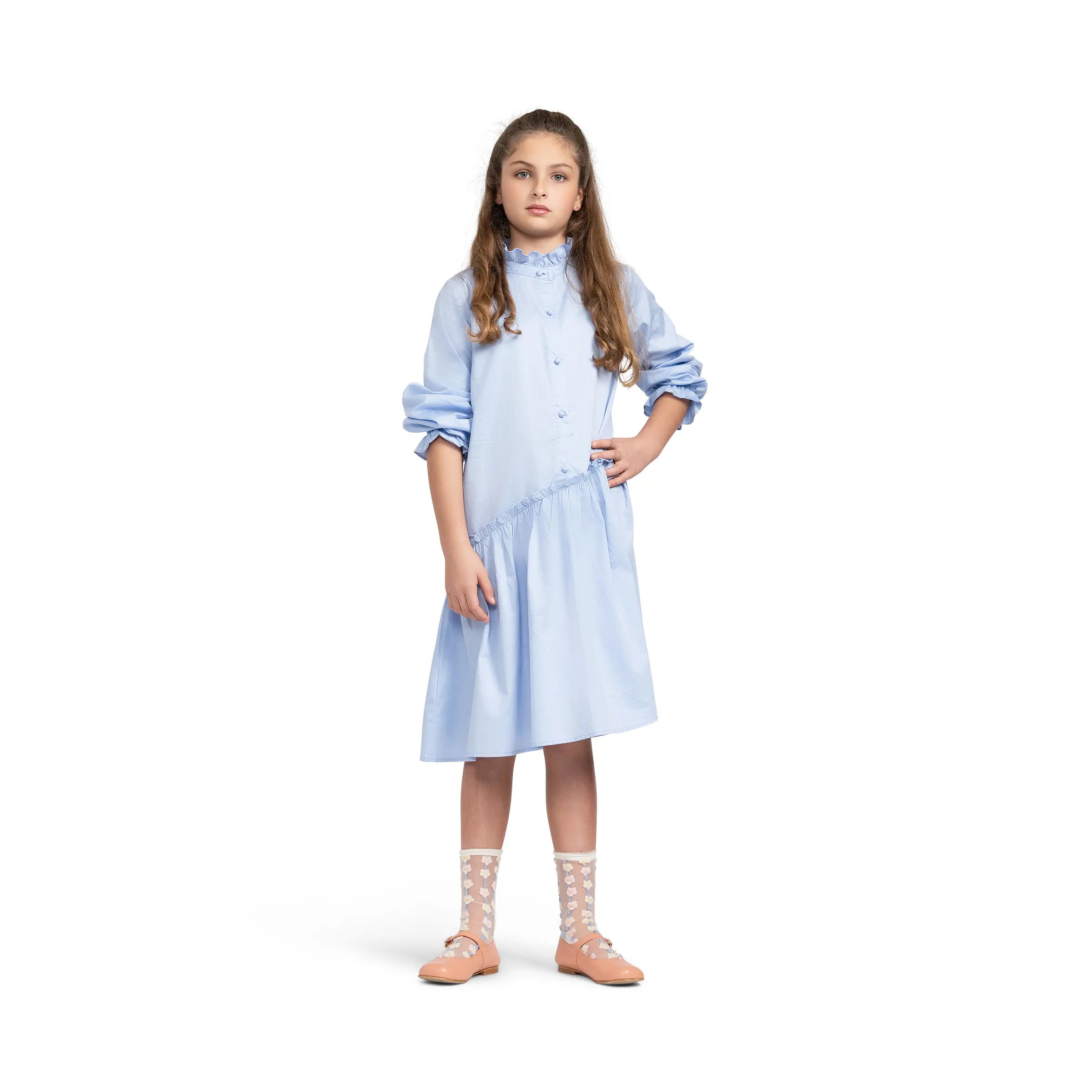 Girl modeling Puvu Pior® blue dress with hand on hip, highlighting the sophisticated fit and rolled cuff details.