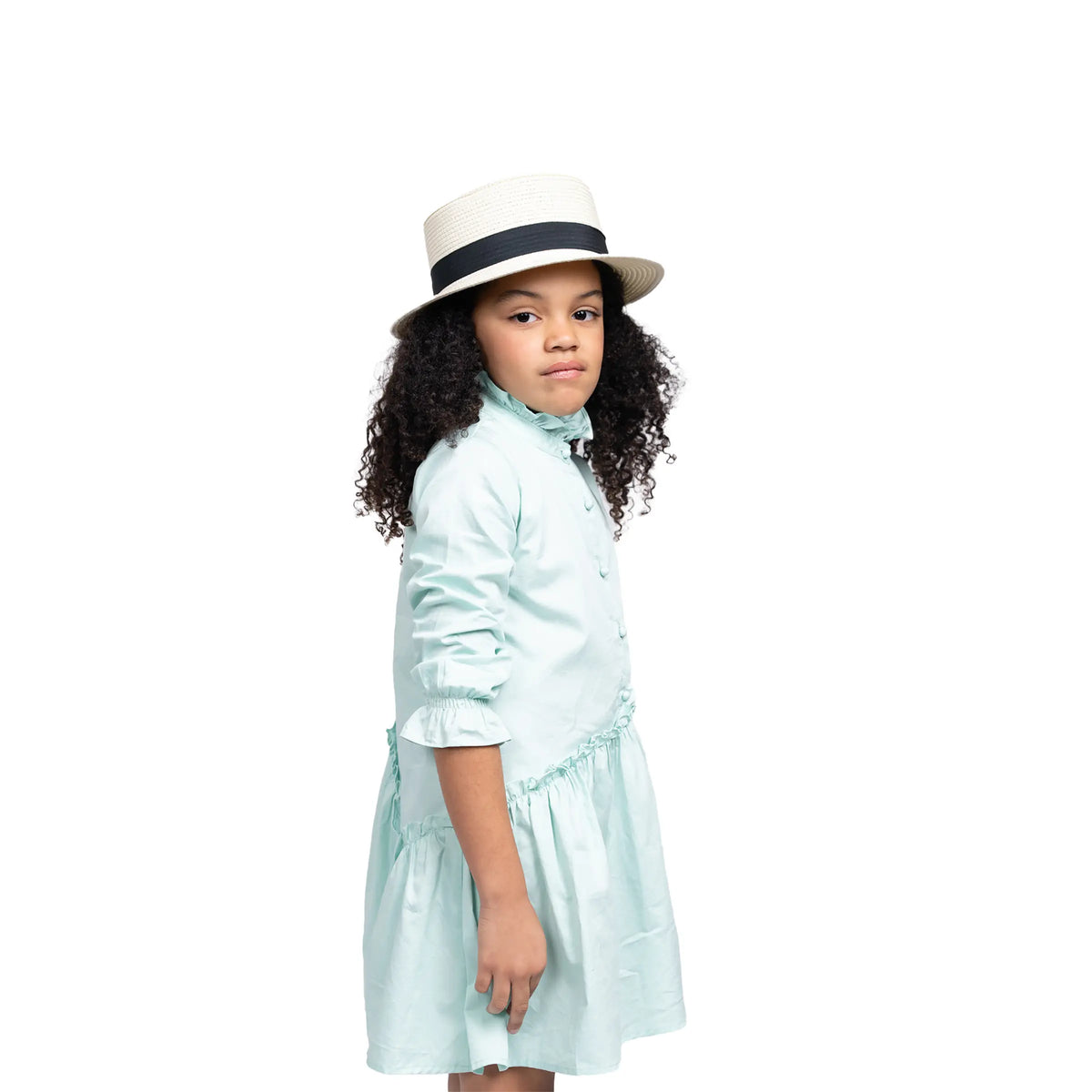 Close-up of Puvu Pior® mint green dress, highlighting the ruffled mock neck, button placket, and straw hat styling.