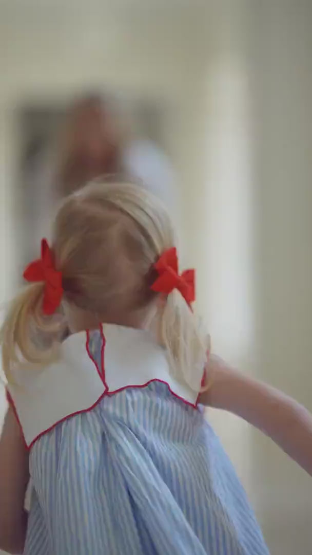 A cinematic campaign video for Puvu Pior® featuring a young girl and her mother in a luxury estate setting. The film highlights the SS2026 collection, including the signature blue pinstripe dress with a sailor collar, showcasing heartfelt family bonding and the WOVENBOND™ philosophy.